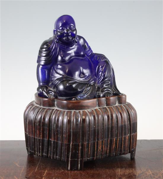 A Chinese Beijing blue glass seated figure of Budai, late 19th / early 20th century, total height 27cm, chip to Budais robes